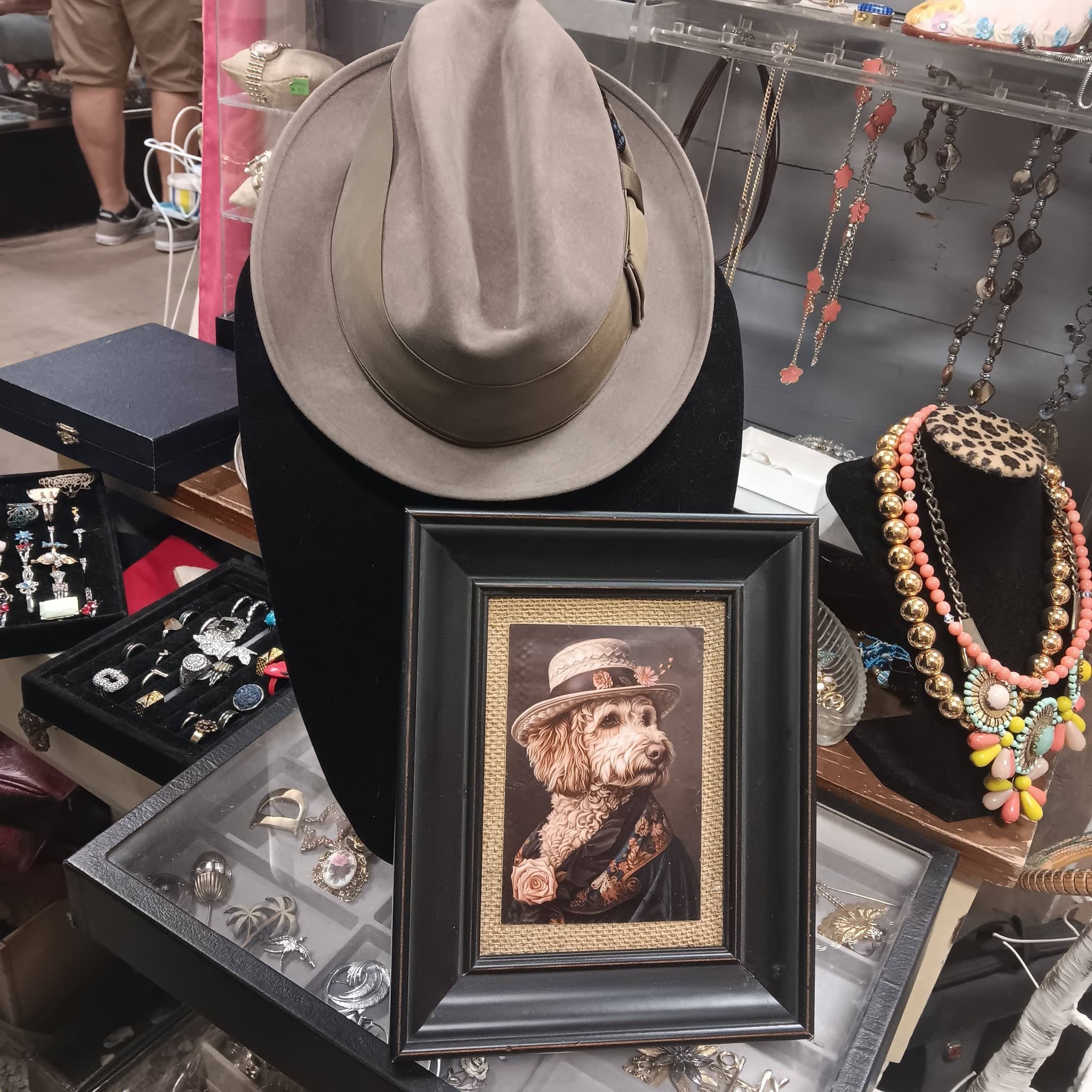 Western hats, vintage jewelry in display cases, beaded necklaces, and framed artwork